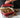 Baking dish filled with golden bacon and mushroom stuffing garnished with herbs