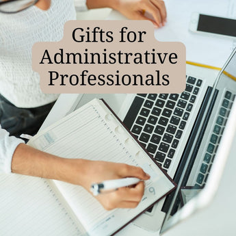 Picture of an administrative professional scheduling her day though a planner. Find the perfect gift for your go-to keeper of the office universe.