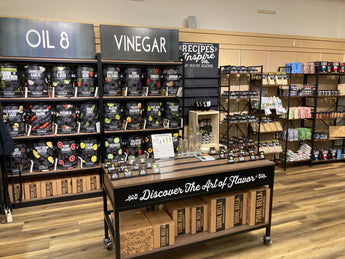 Olivelle gourmet food display featuring infused olive oils, balsamic vinegars, artisan salts, and pastas available at Chivilla Bay