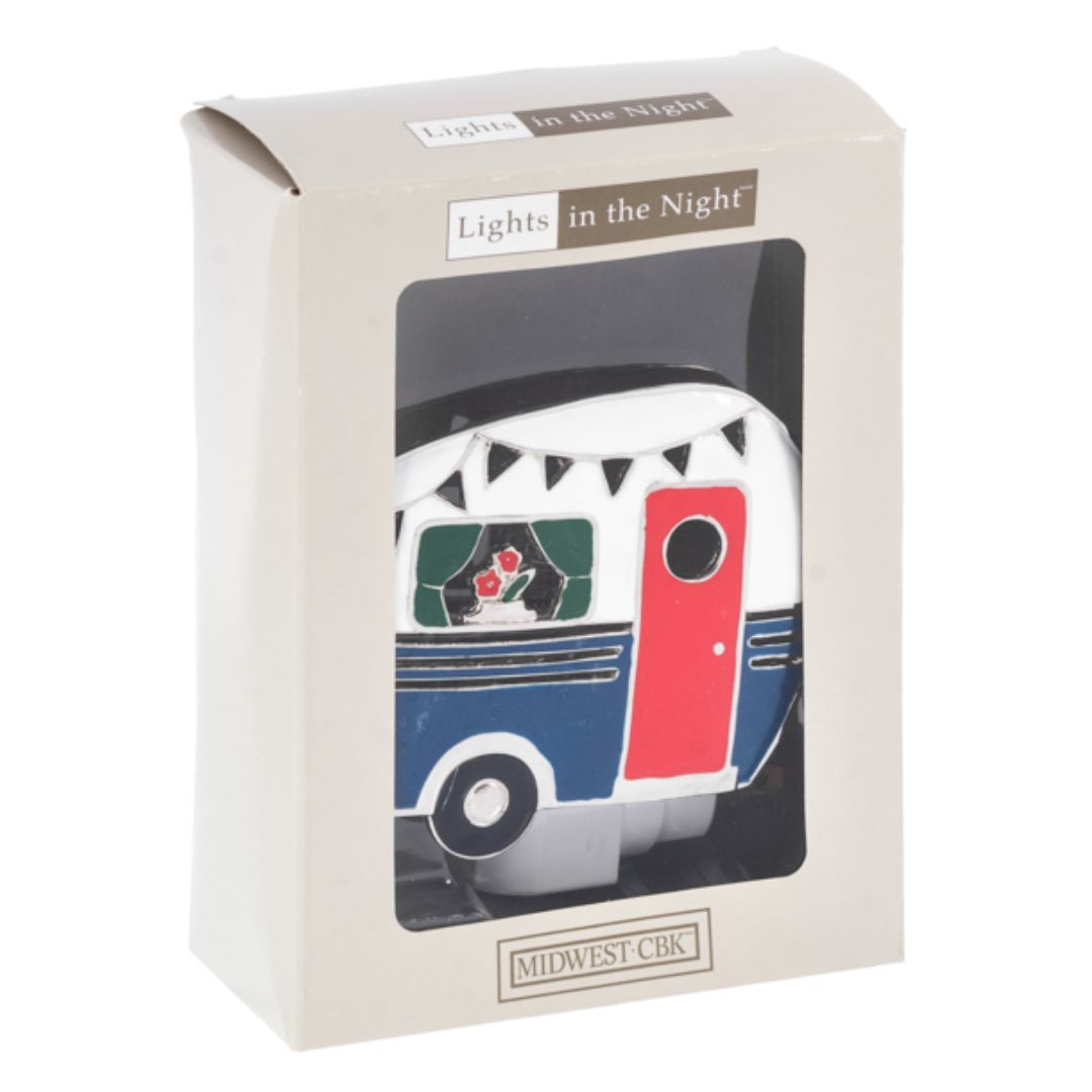 Whimsical Camper Night Light casting a soft, warm glow in a dark camper, featuring a unique camper design in the Chivilla Bay collection.