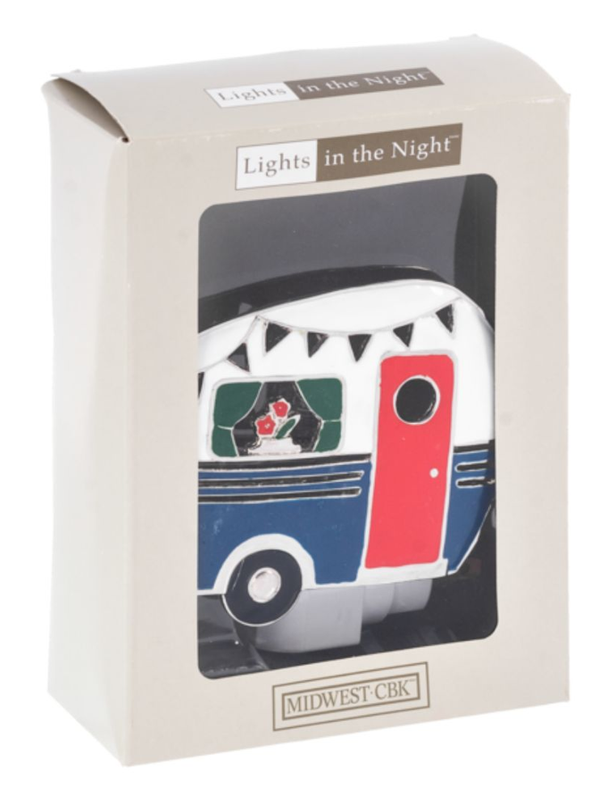 Whimsical Camper Night Light casting a soft, warm glow in a dark camper, featuring a unique camper design in the Chivilla Bay collection.