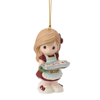 Precious Moments Ornament of a girl holding a tray with '2026' on a white background