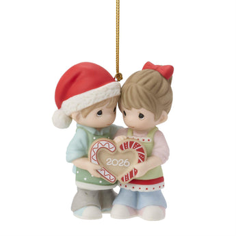 Christmas ornament with two preicous moments children holding a heart-shaped 2026 ornament on a white background