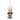 Decorative ornament of a person wearing a red sweater with a green bow on a white background