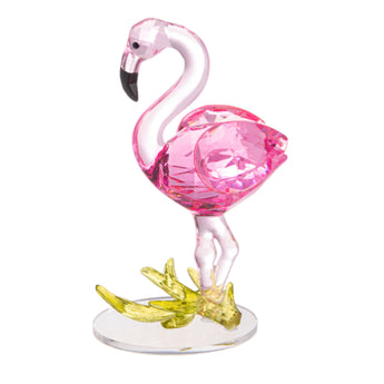 A pink flamingo figurine with a clear base and a yellow flower-like structure at the bottom.