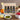 Collection of Olivelle olive oil bottles in a wooden gift box with fruits and a salad in the background.