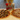 Two pizzas with various toppings on a wooden surface with pizza ingredients.