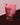 Bag of LL's Kitchen Sweetheart Crunch Granola on a pink and brown gradient background