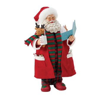 Possible Dreams Santa "My Favorite Bedtime Story" figurine featuring Santa in plaid pajamas and red robe holding a book, mug, and reindeer plush.
