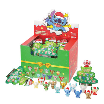 Display of small figurines with a Christmas theme, including a box and multiple figures on a white background.