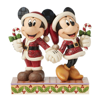 Christmas-themed figurine of Mickey and Minnie Mouse holding candy canes and bows.