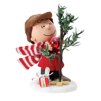 Possible Dreams Charlie Brown's Iconic Tree figurine featuring Charlie Brown in a red coat and striped scarf standing beside his famous Peanuts Christmas tree with a single red ornament.