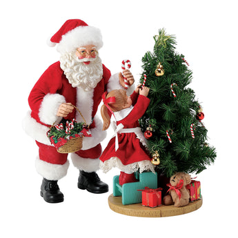 Possible Dreams Nothing Sweeter Santa figurine featuring Santa and a young girl decorating a Christmas tree with candy canes, crafted with Clothtique fabric and hand-painted details.