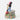 Animated character figurine on a decorative base with flowers and stars.