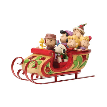 Jim Shore Peanuts A Sleigh Ride to Remember figurine featuring Snoopy, Charlie Brown, Woodstock, and friends riding together in a festive folk-art Christmas sleigh.