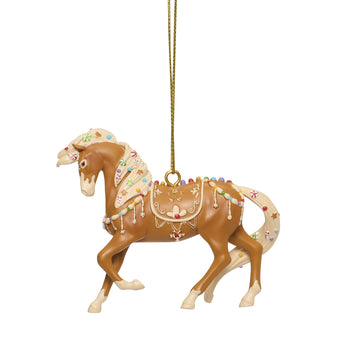 Trail of Painted Ponies Cookie Canter ornament featuring a horse decorated with cookie icing details, candy accents, and festive Christmas colors designed by Isabella Guzman.