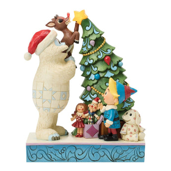 Jim Shore Bumble Holding Rudolph by Christmas tree light-up figurine featuring glowing Rudolph nose and illuminated tree star from the Rudolph Collection.