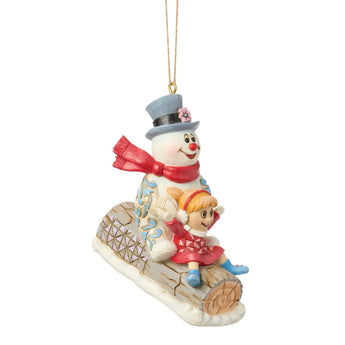 Jim Shore Heartwood Creek Frosty and Karen ornament featuring Frosty the Snowman and Karen riding a rustic log sled with folk-art rosemaling details and winter charm.