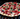 Pizza with various toppings on a grill