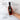 Hand holding a bottle of Olivelle toasted sesame oil with text highlighting its benefits on a marble background.
