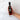 Hand holding a bottle of Olivelle Toasted Sesame oil against a marble background