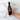 Bottle of Bourbon barrel aged balsamic vinegar held by a hand with text highlighting its qualities on a marble background.