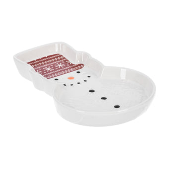 Ceramic snowman spoon rest with red patterened hat, smiling face, and embossed snowflakes. Ideal for holiday kitchen use.