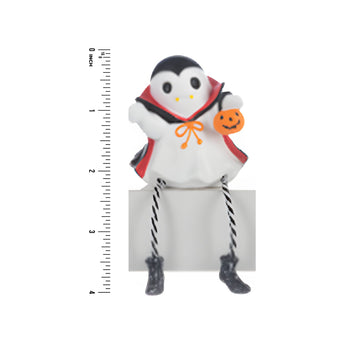 Vampire Ghost figurine in a Halloween costume with a pumpkin, standing next to a ruler for scale on a white background.