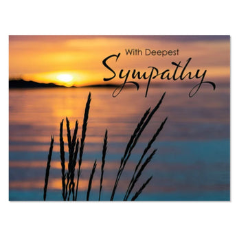 Sympathy card with sunset over water and grass silhouette, text 'With Deepest Sympathy'.