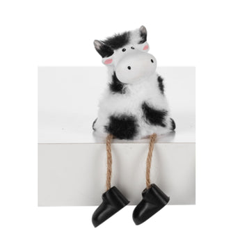 Black and white fluffy cow shelf sitter figurine with soft fur accents with arms by side by Ganz Gift.