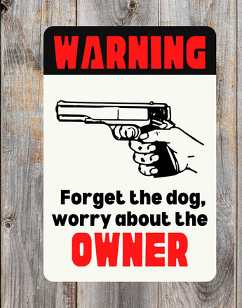 Black and White Warning sign with text "Forget About the Dog, Worry About the Owner" and handgun clip art - bold funny sign for gun owners