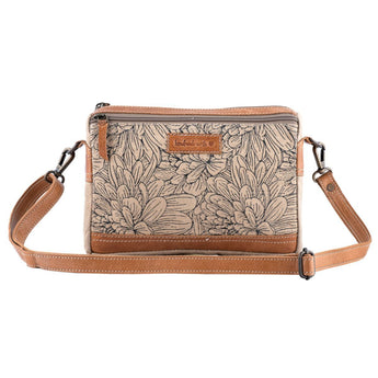 Floral patterned crossbody bag with brown straps on a white background