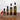 Four bottles of Olivelle Maple-Wood Bacon olive oil with labeled volumes on a marble background.