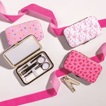 Pink manicure set with various tools on a white background