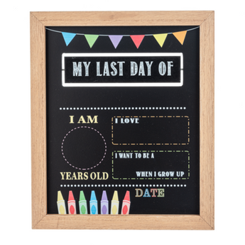 A chalkboard sign with the text 'MY LAST DAY OF SCHOOL' at the top and 'I AM A' to 'DATE' at the bottom, surrounded by colorful polished edges and decorative elements.