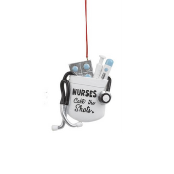 Nurses Call the Shots Christmas ornament featuring stethoscope, pills, and syringes in a nurse's pocket design