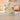 Decorative Noah's Ark with animal figurines on a table in a softly lit room.
