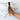 Bottle of Olivelle roasted garlic vinegar held by a hand on a marble surface with text describing its qualities.
