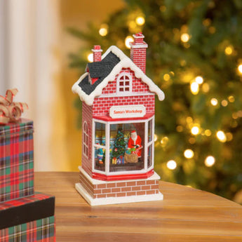 Santa's Workshop lights up with LED lighting in this adorable Snow Globe Water Lantern.