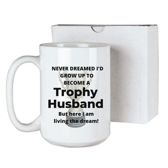 Trophy husband funny coffee mug with a trophy in the background and the text "Never dreamed I'd grow up to become a Trophy husband, but here I am living the dream!" sublimated onto a 15 ounce ceramic coffee mug. Comes with a gift box. Funny gift for his birthday or anniversary.