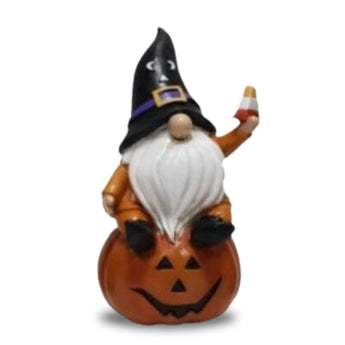 Warlock gnome with candy corn sitting on pumpkin halloween figurine