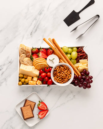 White porcelain South Dakota-shaped bakeware dish on kitchen counter used as a charcuterie tray.