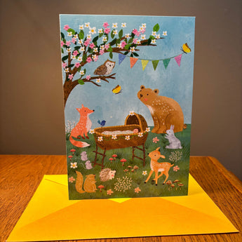Baby Shower Greeting card with forest animals illustration on a wooden surface