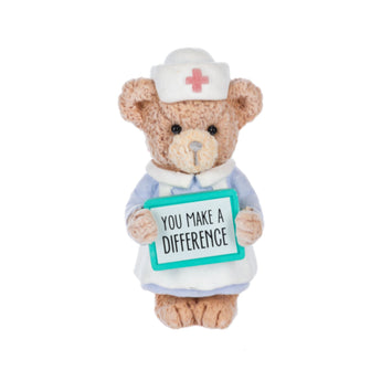 Teddy bear dressed as a nurse holding a sign saying 'You Make a Difference' on a white background