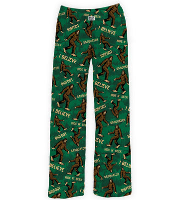 Green pajama pants with Bigfoot and 'I Believe' print on a white background
