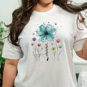 White t-shirt with floral design and 'mama' text worn by a person.