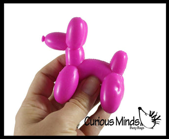 Pink balloon dog stress ball held by a hand with 'Curious Minds Busy Bags' branding.