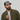 Man wearing a cap with Will Dance for Beer cap and a jacket on a plain background