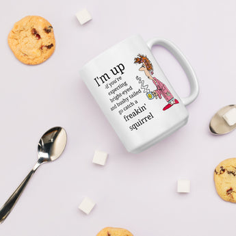 Funny not a morning person coffee mug with cookies and sugar cubes on a pink background.