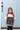 Picture of girl by her front door taking her first day of school photo with sign of the details.